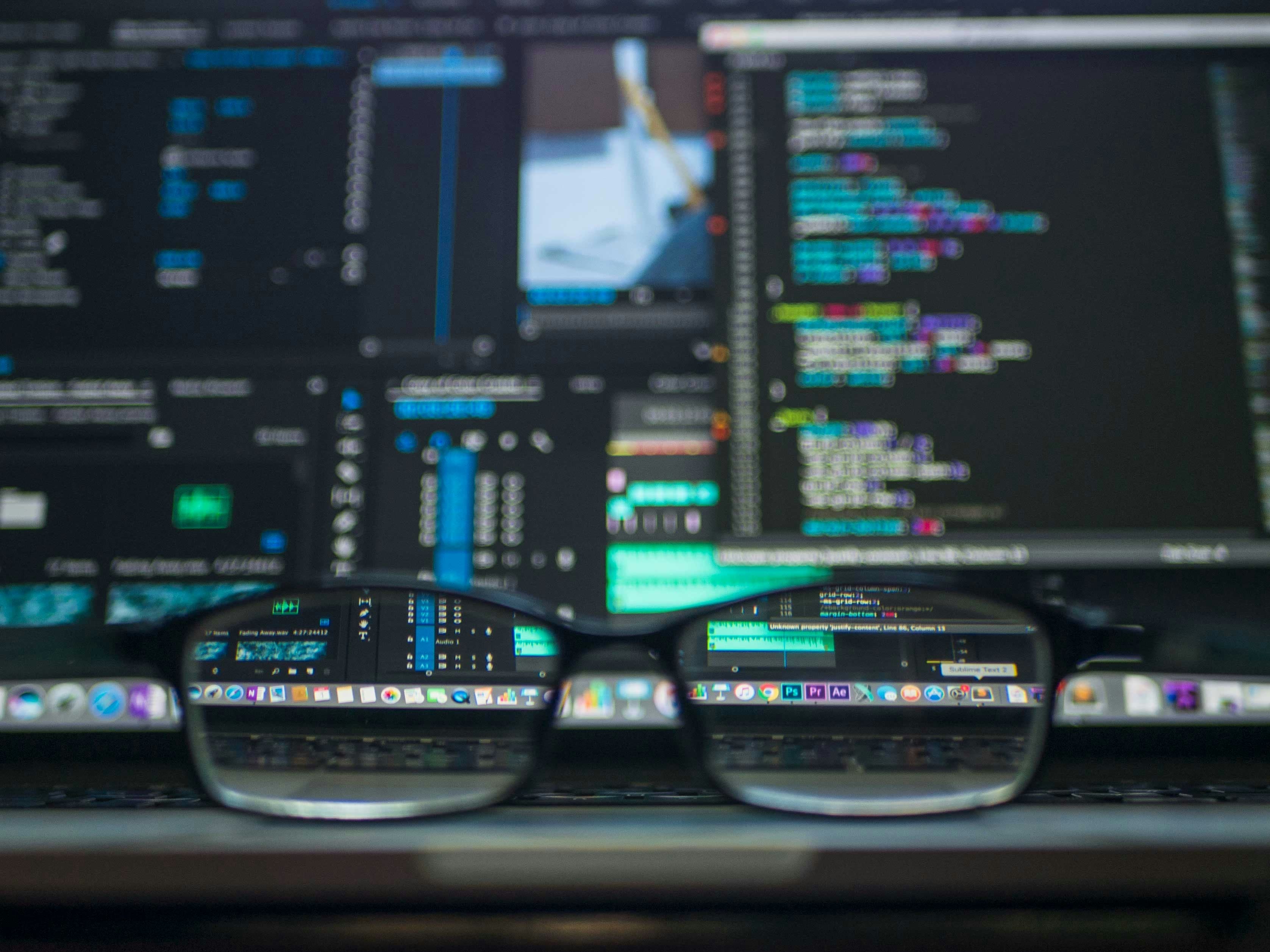 Developer workstation with code editor open, illustrating Claude Code skills loaded on demand