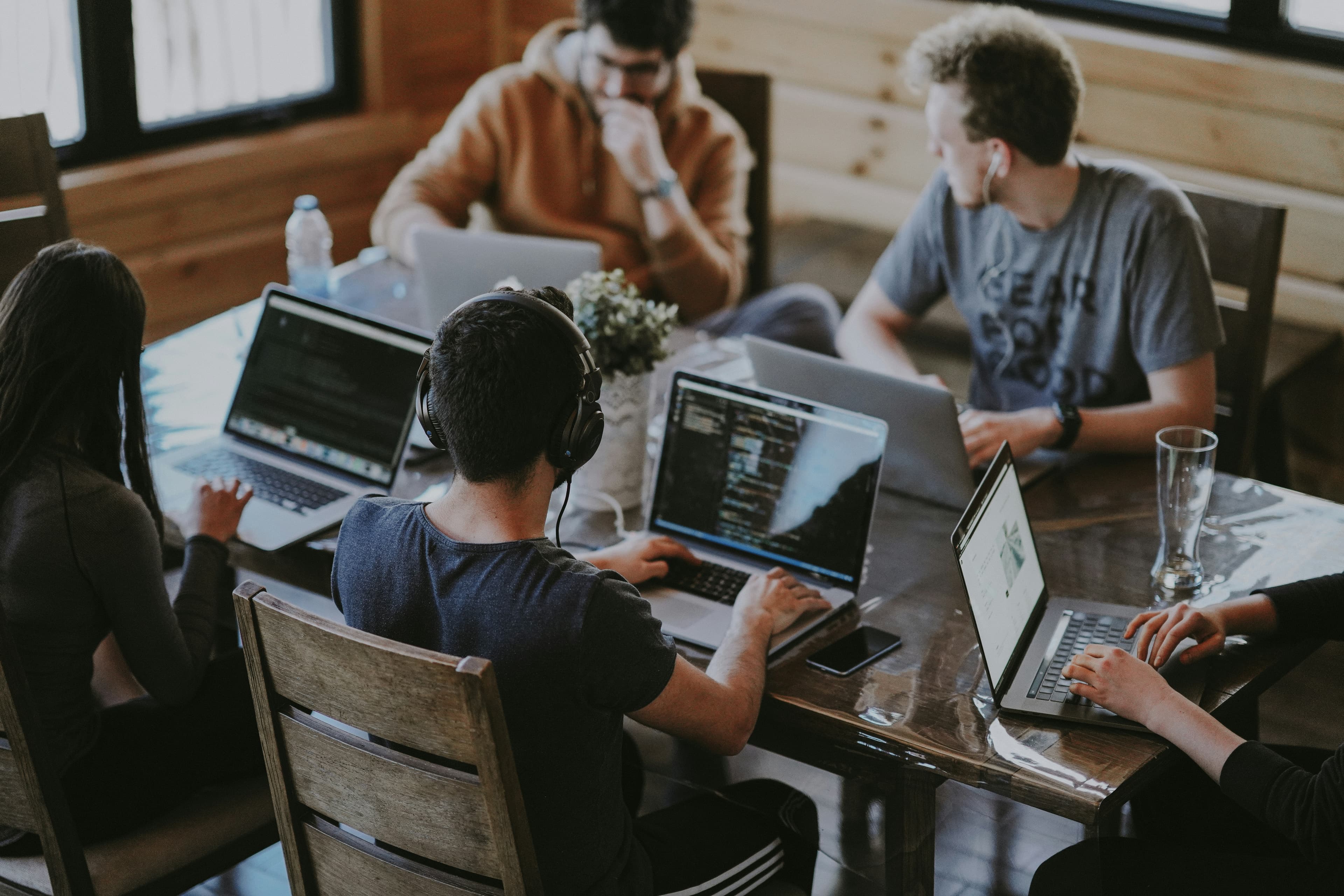 Two developers working together at a computer, representing AI pair programming collaboration