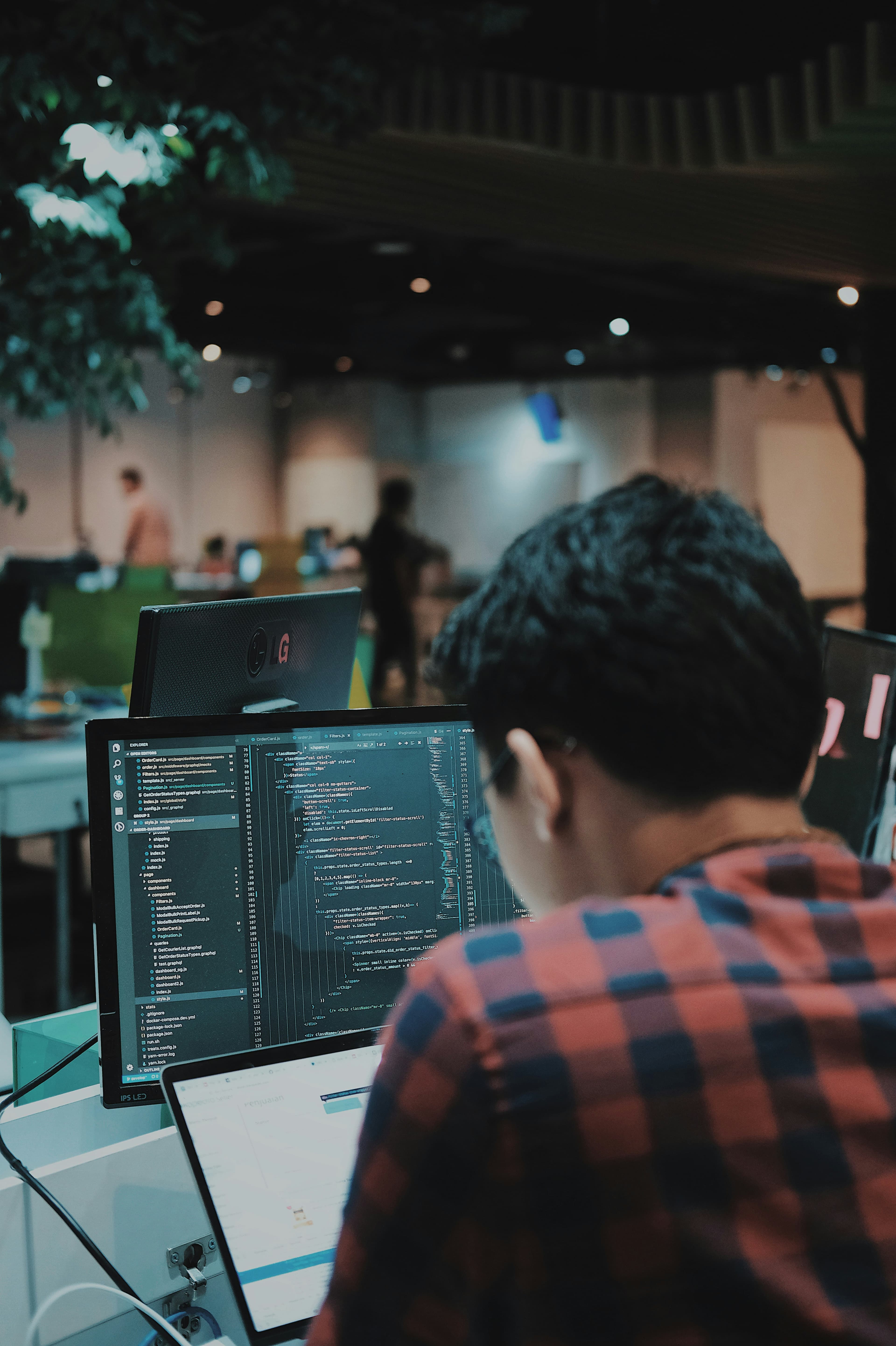 Relaxed developer at laptop trusting AI to write code, representing the vibe coding workflow