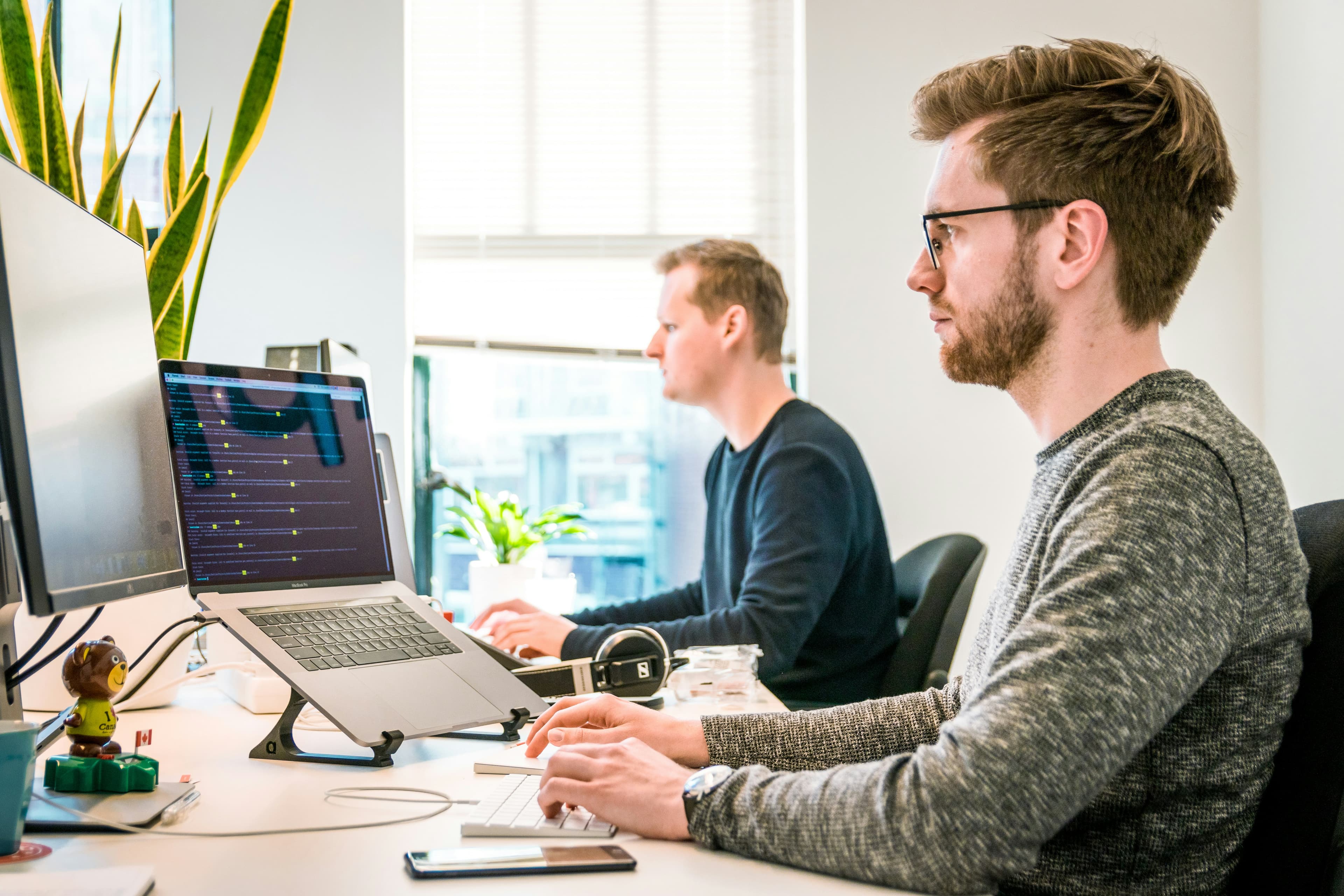 Developer frustrated at laptop repeatedly typing the same explanations to an AI agent